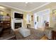 Bright living room showcasing a cozy fireplace, TV, and view into dining area at 213 Billingrath Turn Ln, Cary, NC 27519