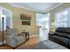 Bright living room offering a comfortable armchair and great natural light at 213 Billingrath Turn Ln, Cary, NC 27519