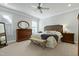 Bright main bedroom with neutral carpet, a dresser, windows, and a ceiling fan at 213 Billingrath Turn Ln, Cary, NC 27519
