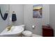 Classic powder room with sink, toilet, and wall art, offering a refined and intimate space at 213 Billingrath Turn Ln, Cary, NC 27519