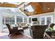 Bright sunroom with wood ceiling, skylights, multiple windows, and comfortable seating creating a relaxing indoor oasis at 213 Billingrath Turn Ln, Cary, NC 27519