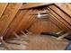 Exposed beams and unfinished flooring characterize this unfinished attic space at 213 Billingrath Turn Ln, Cary, NC 27519