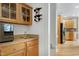 A convenient wet bar boasts glass shelving, a mini refrigerator, a sink, and stylish wine racks at 213 Billingrath Turn Ln, Cary, NC 27519