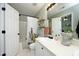 Well-lit bathroom featuring a shower with curtain, a toilet, and vanity with a large mirror at 2133 Persimmon Ridge Dr, Raleigh, NC 27604