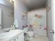 Cozy bathroom with framed mirror, white vanity, toilet, and a themed shower curtain at 2133 Persimmon Ridge Dr, Raleigh, NC 27604