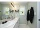 Bathroom with double sinks, decoratively framed mirrors, and black hardware at 2133 Persimmon Ridge Dr, Raleigh, NC 27604