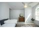Bright bedroom featuring a daybed, ceiling fan, and natural light through the large window at 2133 Persimmon Ridge Dr, Raleigh, NC 27604