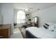 Bright bedroom with a large window, ceiling fan, white walls, and neutral-toned decor at 2133 Persimmon Ridge Dr, Raleigh, NC 27604