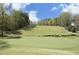 Picturesque view of a well-maintained golf course with lush greenery and blue skies at 2133 Persimmon Ridge Dr, Raleigh, NC 27604