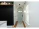 Bright hallway with light gray walls and hardwood floors, leading to various rooms at 2133 Persimmon Ridge Dr, Raleigh, NC 27604