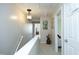 Upstairs hallway with white walls, and doors including one labeled 