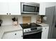 Contemporary kitchen with stainless steel appliances, black hardware, and ample storage at 2133 Persimmon Ridge Dr, Raleigh, NC 27604