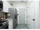 Modern kitchen with stainless steel refrigerator, white cabinets, and neutral wall paint at 2133 Persimmon Ridge Dr, Raleigh, NC 27604