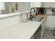 Kitchen sink area with modern faucet, bright countertops, and white cabinetry at 2133 Persimmon Ridge Dr, Raleigh, NC 27604