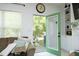View of the back patio from the living room couch, with an open door and green door trim at 2133 Persimmon Ridge Dr, Raleigh, NC 27604