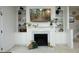 Bright living room featuring a fireplace, built-in shelves, cabinets and a wall-mounted television at 2133 Persimmon Ridge Dr, Raleigh, NC 27604