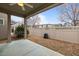 A covered patio looking into the fenced backyard, perfect for relaxing and entertaining outdoors at 219 Begen St, Morrisville, NC 27560