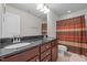Elegant bathroom featuring a double vanity with granite countertop and decorative shower curtain at 219 Begen St, Morrisville, NC 27560