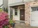 Inviting entryway with stone accents, a dark wood door, and potted plants on the front porch at 219 Begen St, Morrisville, NC 27560