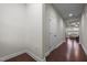 Clean hallway with hardwood floors leading to the open-concept living area and kitchen at 219 Begen St, Morrisville, NC 27560