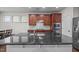 Kitchen with a center island, granite countertops, and white backsplash at 219 Begen St, Morrisville, NC 27560