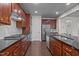 Kitchen features dark wood cabinets, granite countertops, and stainless steel appliances at 219 Begen St, Morrisville, NC 27560