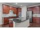 Well-equipped kitchen with dark cabinets, stainless steel appliances, and black countertops at 219 Begen St, Morrisville, NC 27560