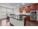 Bright kitchen featuring wood cabinets, stainless appliances, and a dining table at 219 Begen St, Morrisville, NC 27560