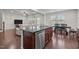 Open concept kitchen and living area with granite countertops and stainless appliances at 219 Begen St, Morrisville, NC 27560