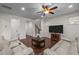 Comfortable living room with hardwood floors, a ceiling fan, and staircase access to the upper level at 219 Begen St, Morrisville, NC 27560