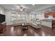 Spacious living room with hardwood floors, a ceiling fan, and an open view to the kitchen at 219 Begen St, Morrisville, NC 27560