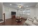 Bright living room with hardwood floors, a ceiling fan, and plenty of natural light from the surrounding windows at 219 Begen St, Morrisville, NC 27560