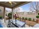 Covered patio featuring an outdoor dining set, a ceiling fan, and a view of the landscaped backyard at 219 Begen St, Morrisville, NC 27560