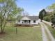 Aerial view of a well-kept home, detached garage, gravel driveway and serene surroundings at 221 Walkers Way, Willow Springs, NC 27592