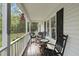 Inviting front porch featuring classic rocking chairs, complemented by charming curb appeal at 221 Walkers Way, Willow Springs, NC 27592