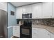 Clean kitchen featuring stainless appliances, granite countertops and stylish backsplash at 221 Walkers Way, Willow Springs, NC 27592