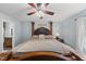 Spacious main bedroom with a large four-poster bed and hardwood floors at 221 Walkers Way, Willow Springs, NC 27592