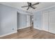 Spacious bedroom features ceiling fan and vinyl floors, and a view into the kitchen at 2306 Stafford Ave # A, Raleigh, NC 27607