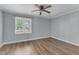 Bedroom features a bright window and vinyl floors, plus neutral paint scheme at 2306 Stafford Ave # A, Raleigh, NC 27607
