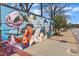 Close up of a large mural on a brick wall featuring flowers, birds, and greenery at 2306 Stafford Ave # A, Raleigh, NC 27607