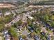 An aerial view showcasing the neighborhood's layout with trees and proximity to the highway and nearby commercial areas at 2340 Florida Ct, Raleigh, NC 27615