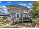 Home's backyard with deck, stairs, landscaping and an umbrella at 2340 Florida Ct, Raleigh, NC 27615