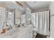 Bathroom featuring a double sink vanity, a colorful stained glass window, and shower with curtain at 2340 Florida Ct, Raleigh, NC 27615