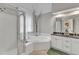 Bathroom with a soaking tub, a glass enclosed shower, and a dual sink vanity at 2340 Florida Ct, Raleigh, NC 27615