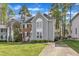 Two-story home with brick and gray siding, featuring a well-maintained lawn and inviting curb appeal at 2340 Florida Ct, Raleigh, NC 27615