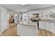 Open concept kitchen featuring a large kitchen island, stainless steel appliances and white cabinetry at 2340 Florida Ct, Raleigh, NC 27615