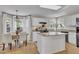 Bright kitchen with white cabinetry, granite countertops, island, and stainless steel appliances and table with 4 chairs at 2340 Florida Ct, Raleigh, NC 27615