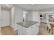 Kitchen island with granite countertops and white cabinetry, with views to the living room and bedrooms at 2340 Florida Ct, Raleigh, NC 27615