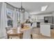 Bright eat-in kitchen boasts white cabinets, granite counters, stainless appliances, wooden table and 4 chairs at 2340 Florida Ct, Raleigh, NC 27615