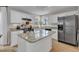 Kitchen boasts white cabinets, granite countertops, stainless steel appliances and large kitchen island at 2340 Florida Ct, Raleigh, NC 27615